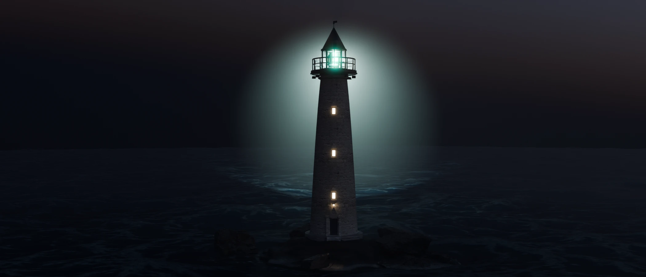 El faro terminado de noche, con la luz encendida